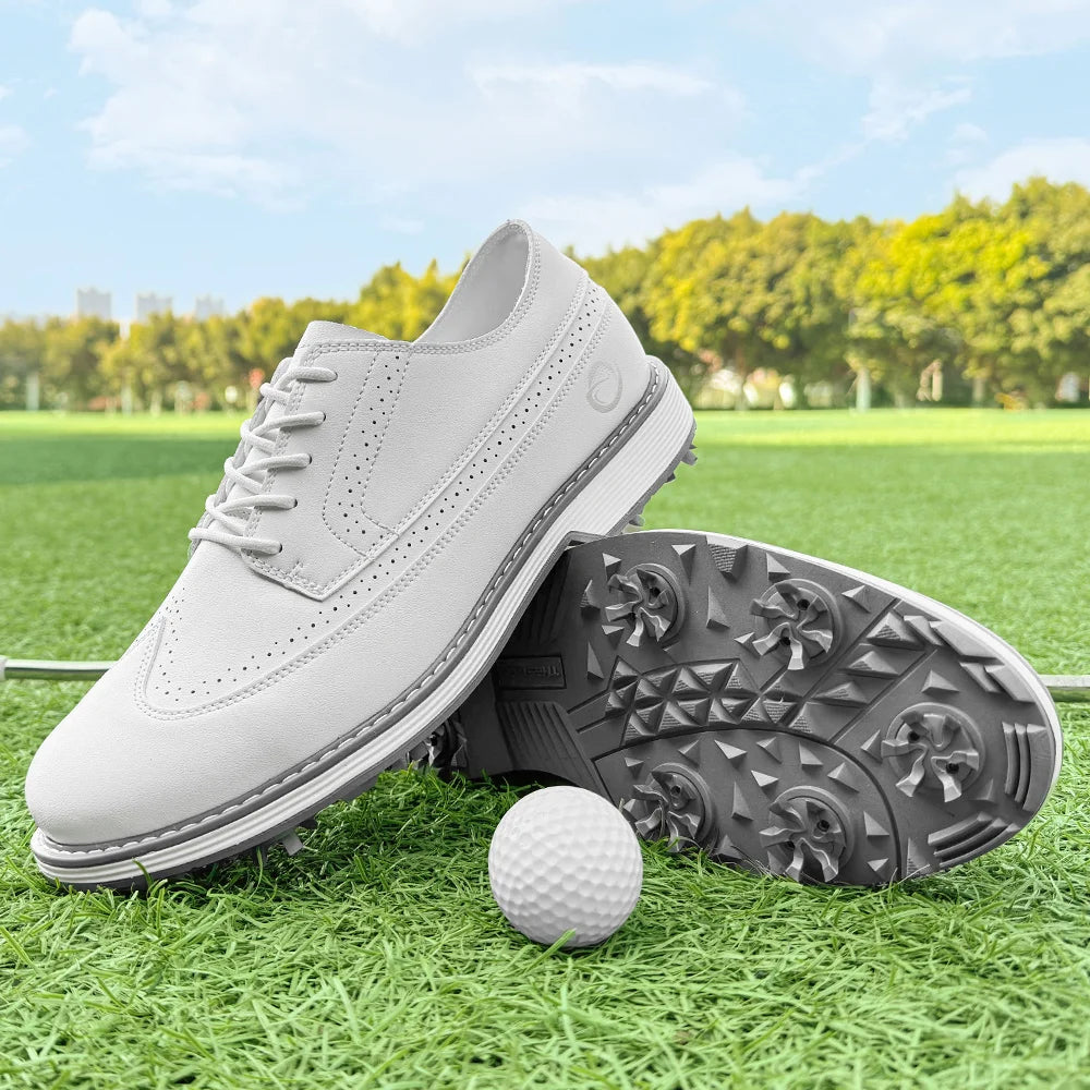 White golf shoes on grass beside a golf ball